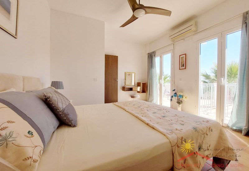 light flooded bedroom with two french terrace doors