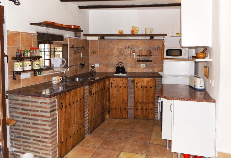 Traditional rustic kitchen, fully equipped with window.