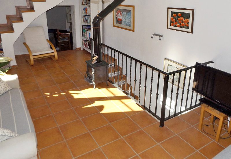 Open lounge with staircase, sofa and televeision to chill out.