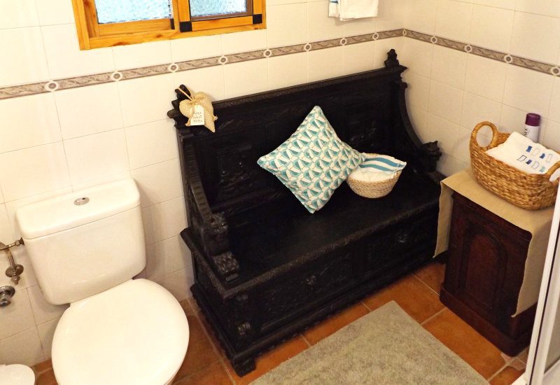 Bathroom of the guest room with bench.