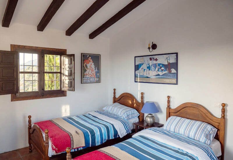 Bedroom B is equipped with two beds and has a sloping roof with beautiful wooden beams