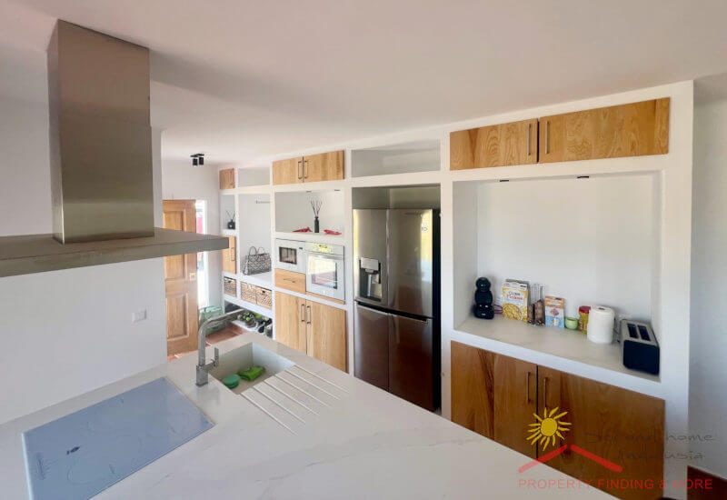 The fitted kitchen is brick-built and has a double fridge