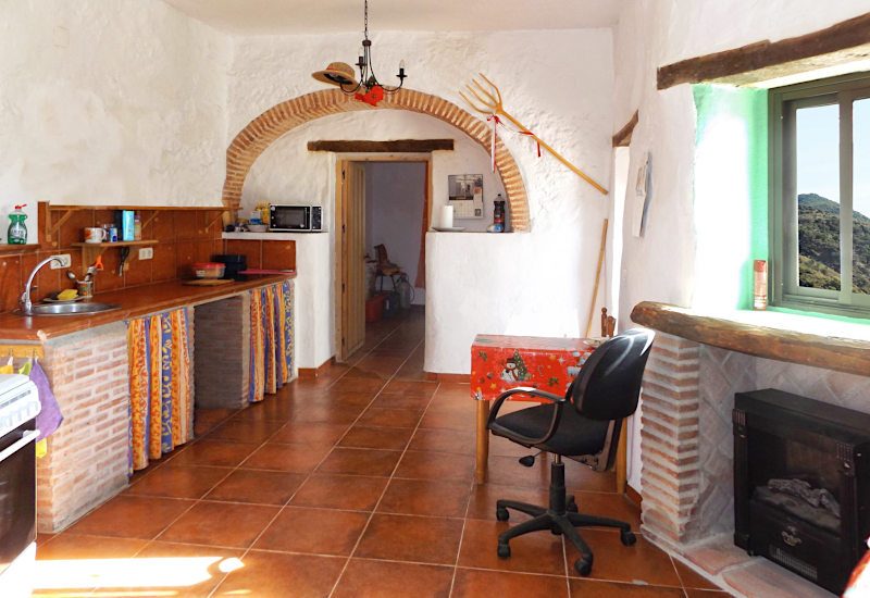 The kitchen has a lot of light, a dining area and a heater