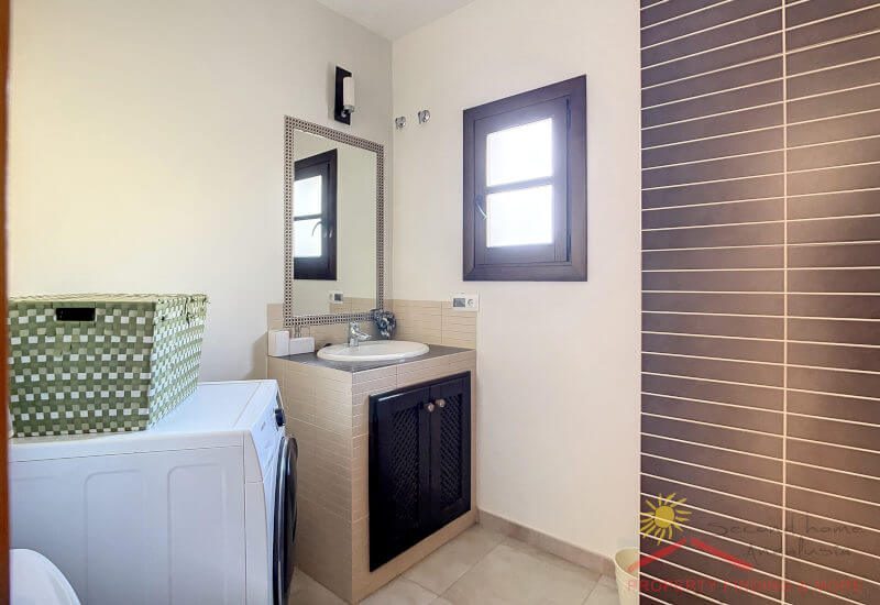 A separate modern bathroom is equipped with shower, toilet and basin