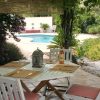 Table for lunch in the shadow of the wine with pool in the background