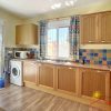 Fully equipped kitchen with large window and double door to the garden