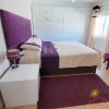 Bedroom 2 modern bedroom with kingsize bed and pitched in purple with a glass-door wardrobe, heating and a window