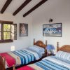 Bedroom B is equipped with two beds and has a sloping roof with beautiful wooden beams