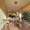covered front terrace in the sun with pergola