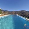 The pool lays in front of the house and offers a stunning view over the landscape