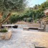 Rustic terrace with natural stones and old trees 