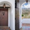 Chic entrance door made of wood in Moroccan style Chic entrance door made of wood in Moroccan style, from the entrance there is a phantastic view on the hills of the Axarquia