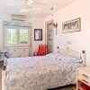 2nd bedroom Large 2nd bedroom with wide bed and chair, window and ceiling fan