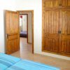 The guest bedroom has a twin bed and a built-in wardrobe with wooden door