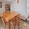 Dining room with wooden table for four persons near the kitchen