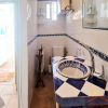 The small en-suite guest bathroom has a coulorful tiled basin 