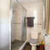 A nice en-suite bathroom contains a large shower, a toilette and basin 