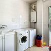 an extra utility room with dryer, washing machine and basin