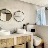 A master en-suite bathroom withtwo basins a toilette and a shower 