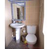 Simple bathroom with washbasin, toilet and shower