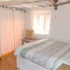 Guest bedroom with ceiling fan, typical andalusian village window and wardrobes.