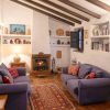 Cosy living room with fireplace and sloping beamed ceiling
