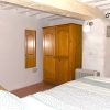 guest bedroom with wooden wardrobe and rustical wall