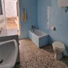 Old bathroom with blue titles and old equipment