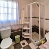 Second bathroom with shower, toilet and washbasin, as well as large windows