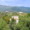 The white house for sale in the middle of the land with distant neighbours.