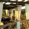 The upper terrace has a wooden framework and curtains for some shade  The upper terrace has a wooden framework and curtains